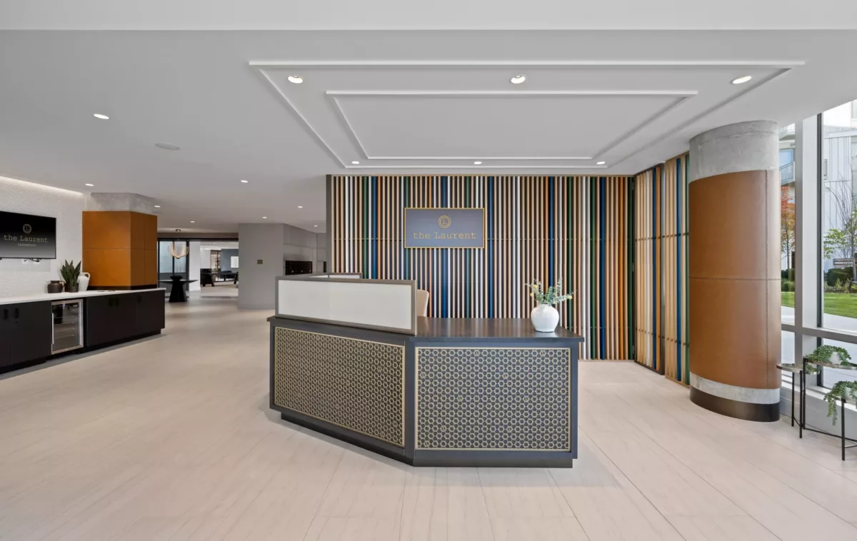 Lobby or reception area with desk, wood accents, and modern lighting.