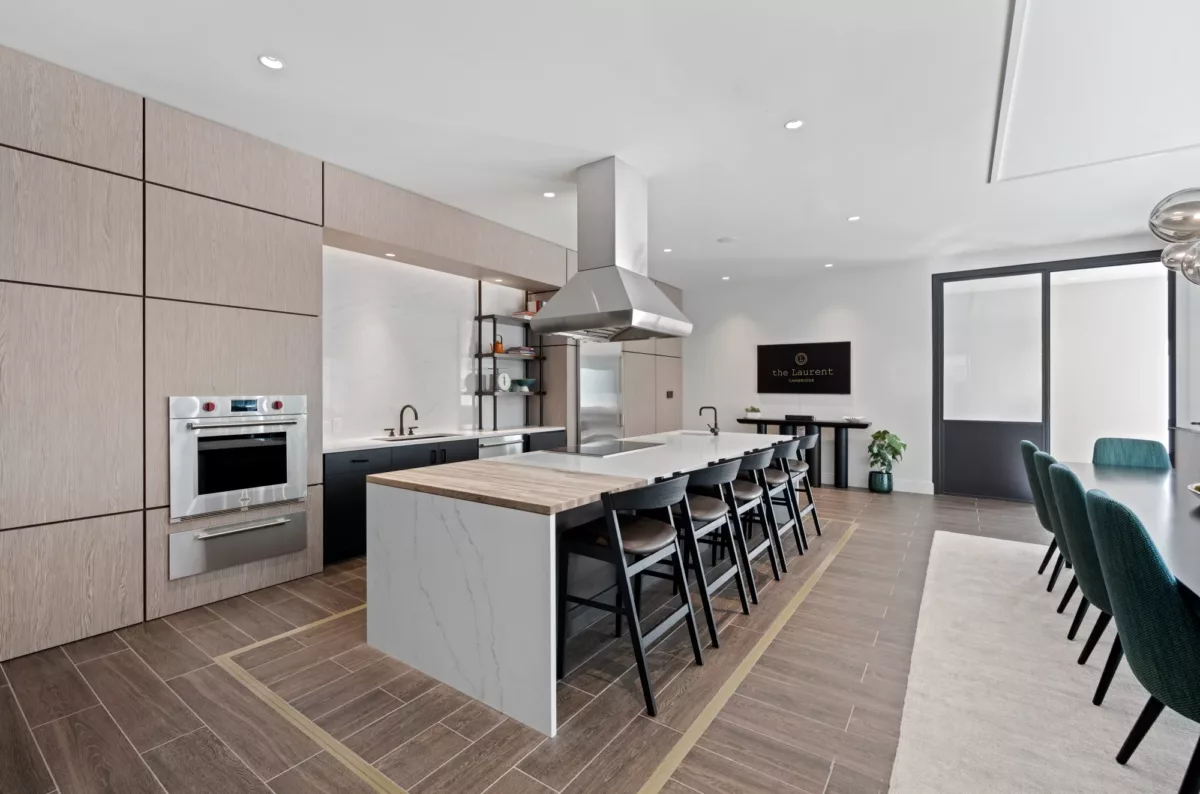 Shared kitchen and dining space with island seating and modern lighting.