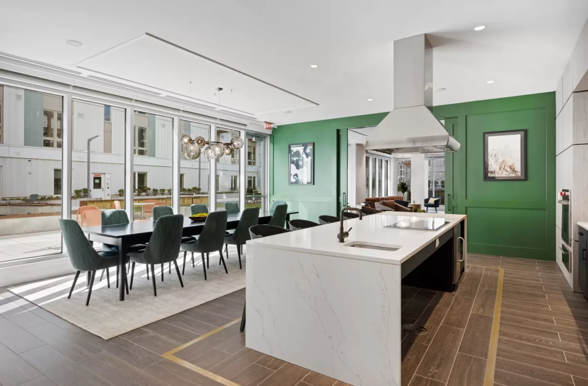Open community kitchen with large island, bar stools, and contemporary finishes.