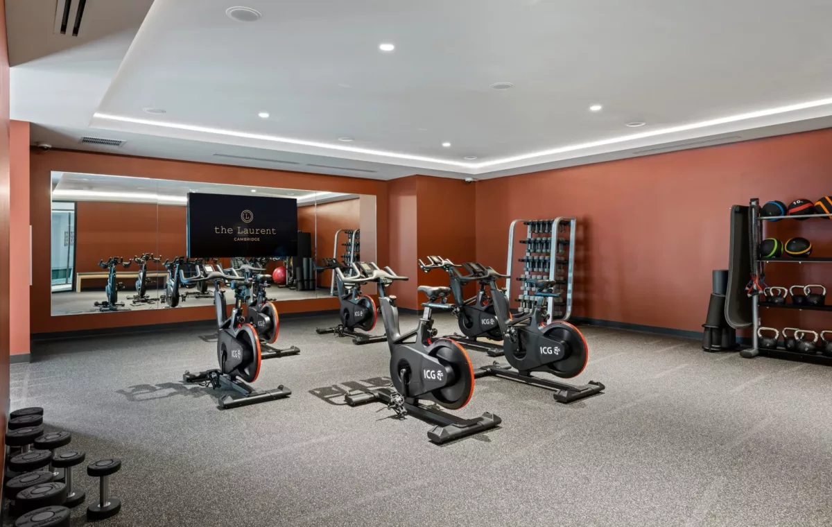 Fitness room with cardio equipment and strength training machines.