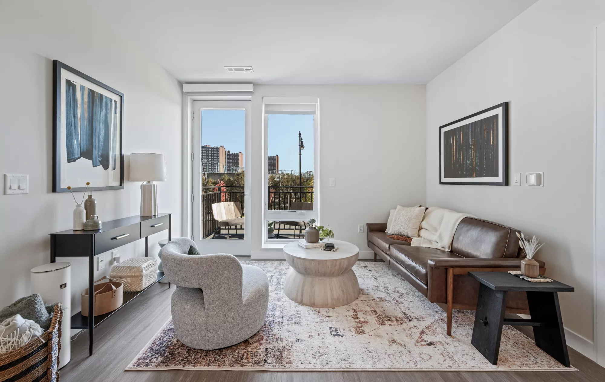 Living room with abundant natural light from floor-to-ceiling windows with roller shades